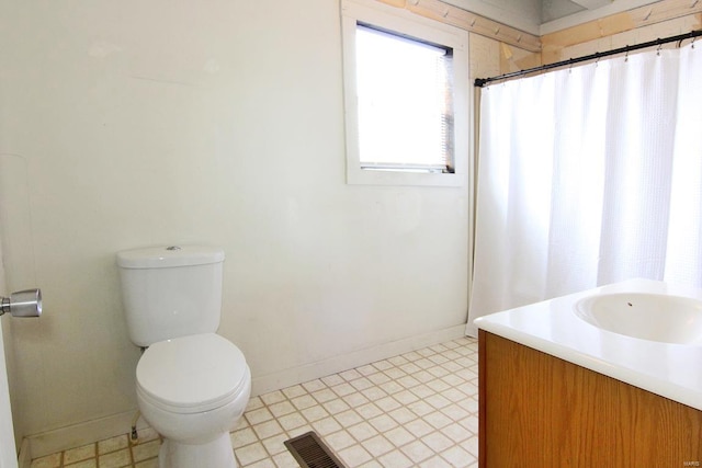 bathroom featuring vanity, toilet, and tile floors