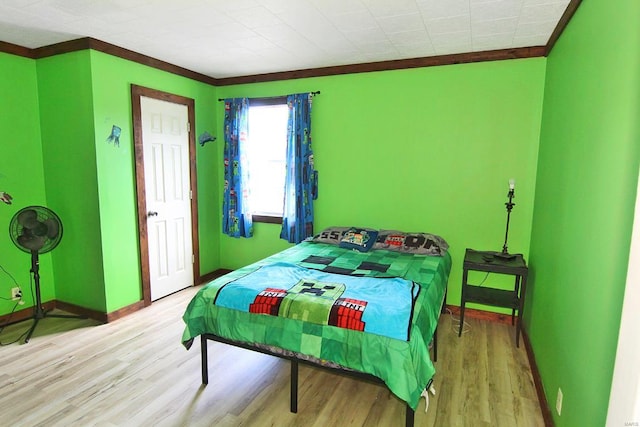 bedroom featuring crown molding and hardwood / wood-style floors