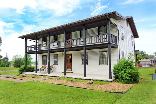 view of front of property featuring a front lawn and a balcony