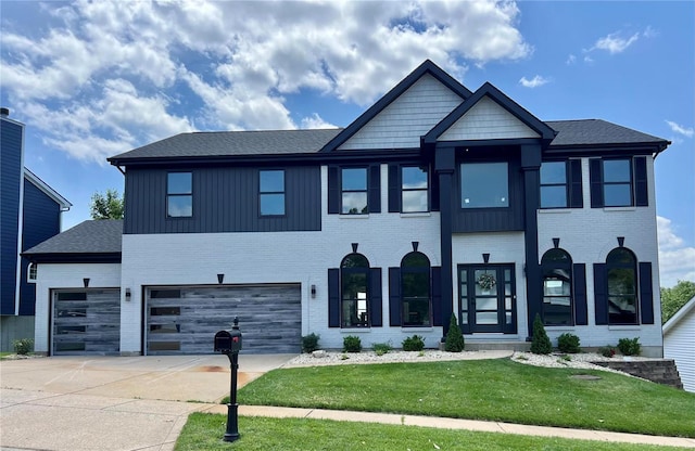 view of front of house with a front yard and a garage