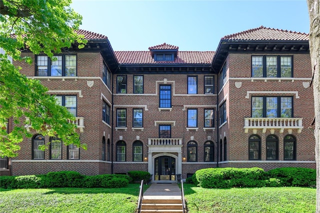 view of front facade with a front yard and french doors