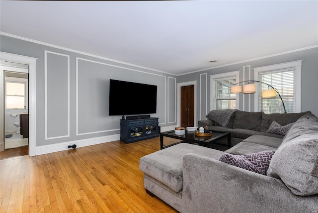 living room with ornamental molding and hardwood / wood-style floors