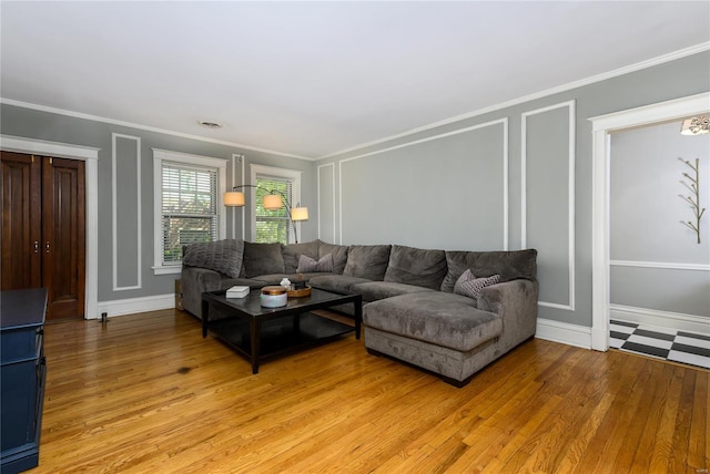 living room with crown molding and light hardwood / wood-style floors