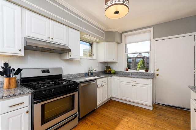 kitchen featuring sink, white cabinetry, light hardwood / wood-style flooring, and stainless steel appliances