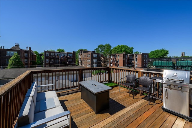 wooden terrace with outdoor lounge area and a grill