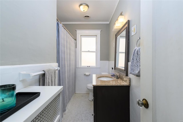 bathroom featuring toilet, tile patterned flooring, tile walls, crown molding, and vanity