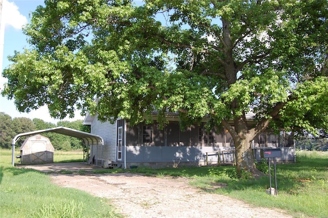 view of front of home with a front lawn and a carport