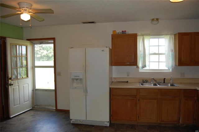 kitchen with sink, plenty of natural light, and white refrigerator with ice dispenser