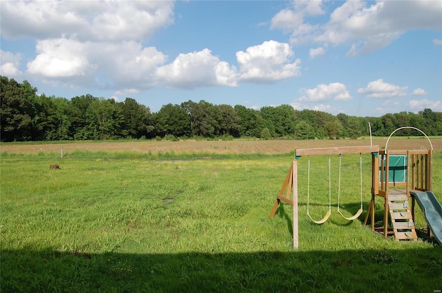 view of jungle gym featuring a lawn