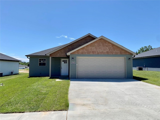 single story home with central AC unit, a garage, and a front yard