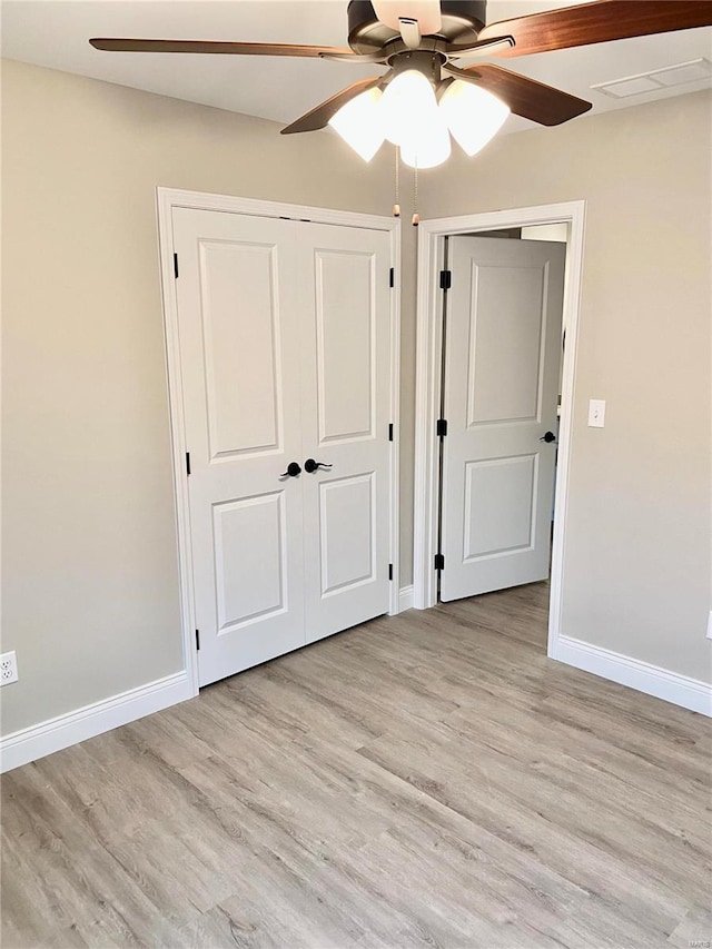 unfurnished bedroom with ceiling fan and light hardwood / wood-style floors