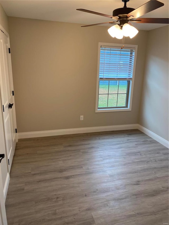 unfurnished room with ceiling fan and wood-type flooring