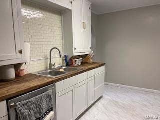 kitchen featuring dishwasher, butcher block counters, white cabinetry, sink, and light tile floors