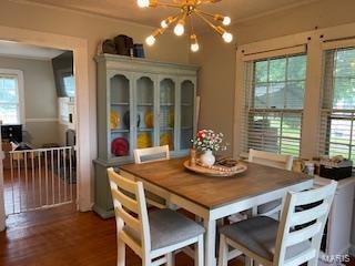 dining room featuring hardwood / wood-style flooring and a chandelier