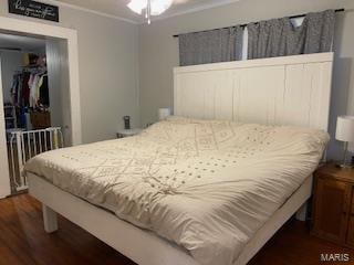 bedroom with dark hardwood / wood-style flooring and a closet