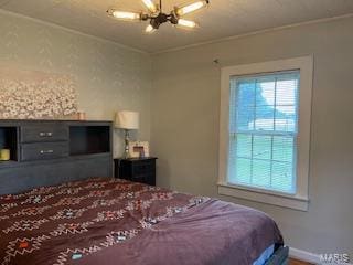 bedroom featuring ceiling fan with notable chandelier