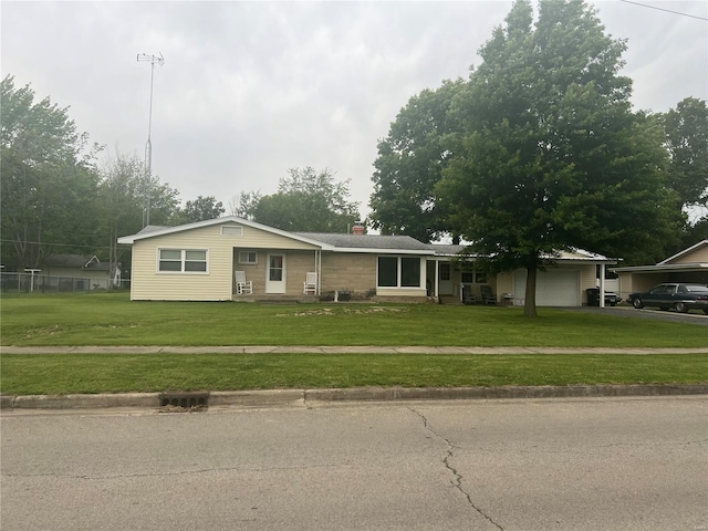 single story home with a garage and a front lawn