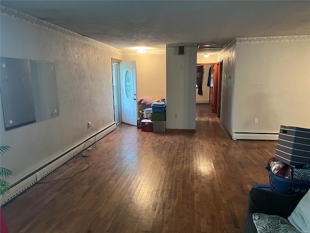 unfurnished room with a baseboard radiator and dark hardwood / wood-style floors