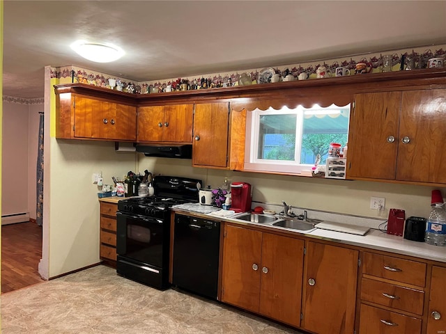 kitchen featuring sink, light hardwood / wood-style floors, a baseboard heating unit, and black appliances