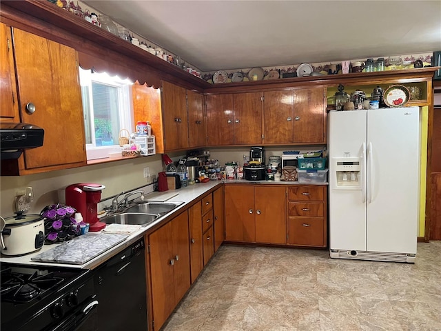 kitchen with black appliances, sink, and extractor fan