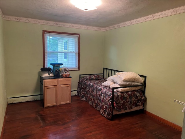 bedroom with a textured ceiling, dark hardwood / wood-style floors, and baseboard heating