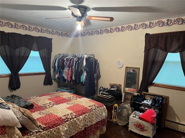 bedroom featuring ceiling fan, dark hardwood / wood-style floors, and a baseboard radiator