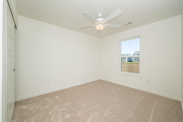 carpeted empty room with ceiling fan