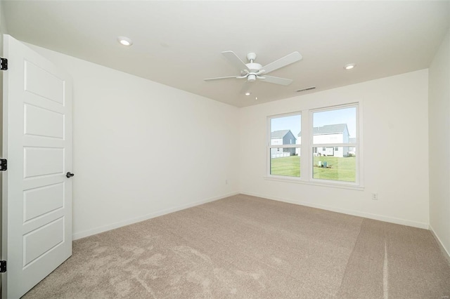 unfurnished room featuring ceiling fan and light colored carpet