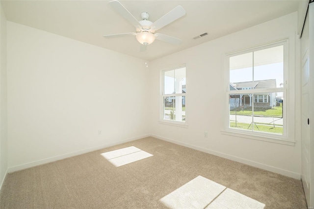 carpeted empty room featuring ceiling fan