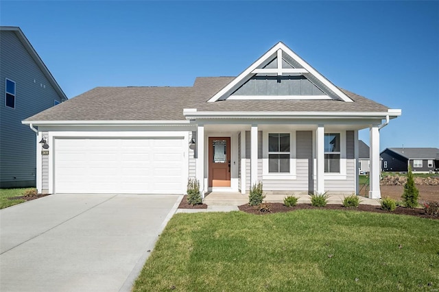 view of front of property with a front yard and a garage