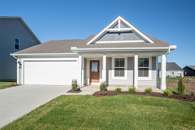 view of front facade with a garage, covered porch, and a front yard