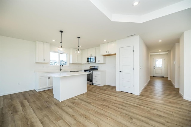 kitchen featuring white cabinetry, light wood-type flooring, and appliances with stainless steel finishes