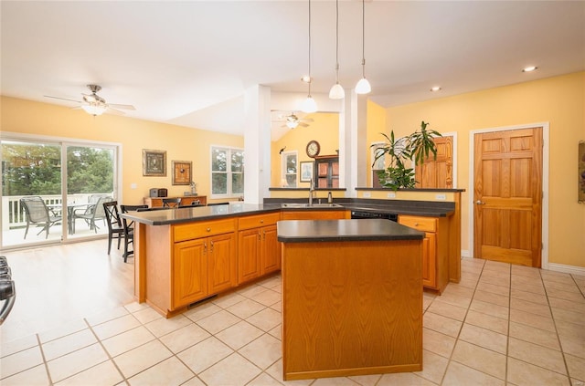 kitchen featuring pendant lighting, a center island, sink, light tile patterned flooring, and kitchen peninsula