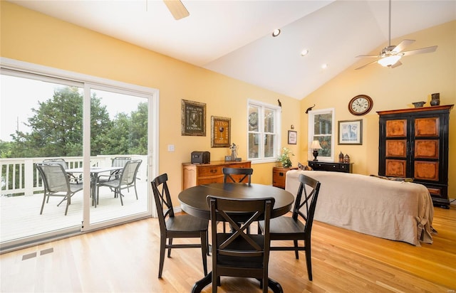 dining room featuring lofted ceiling, ceiling fan, and light wood-type flooring