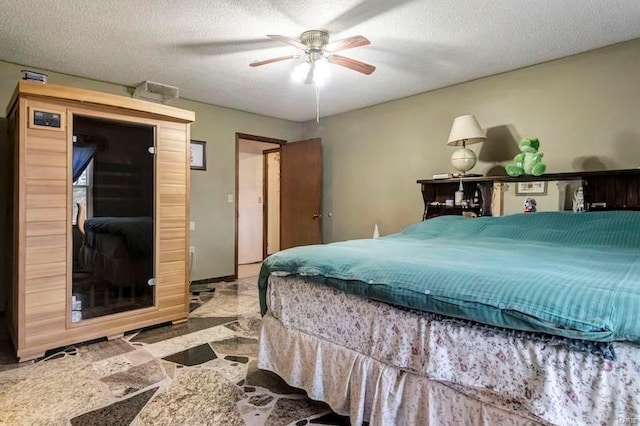 tiled bedroom with a textured ceiling and ceiling fan