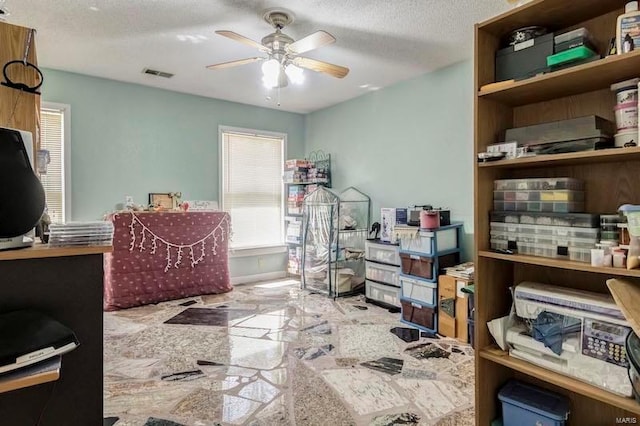 interior space with ceiling fan