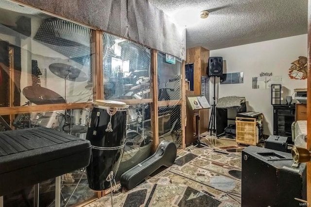 miscellaneous room with a textured ceiling and tile floors