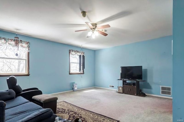 living room featuring a healthy amount of sunlight, carpet flooring, and ceiling fan