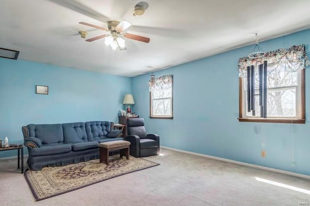 carpeted living room featuring a wealth of natural light and ceiling fan