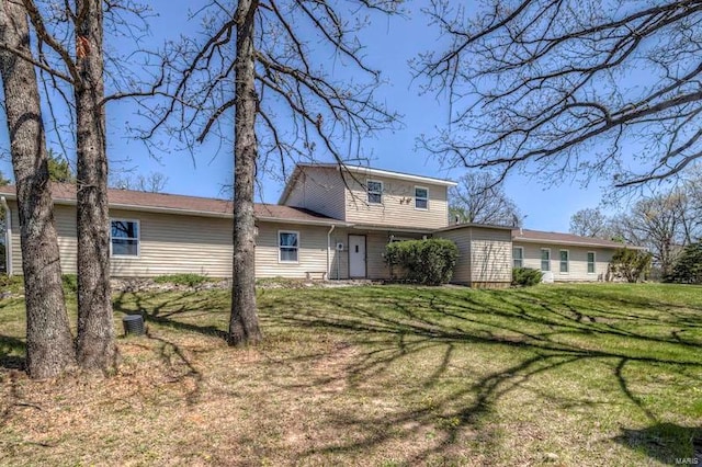 back of house with a lawn