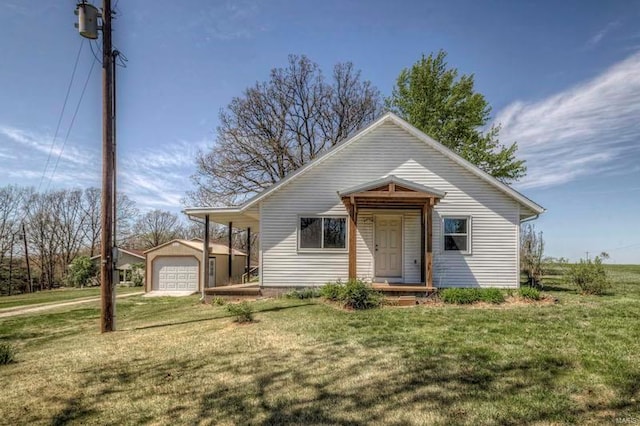 bungalow-style house featuring a garage, a front yard, and an outdoor structure