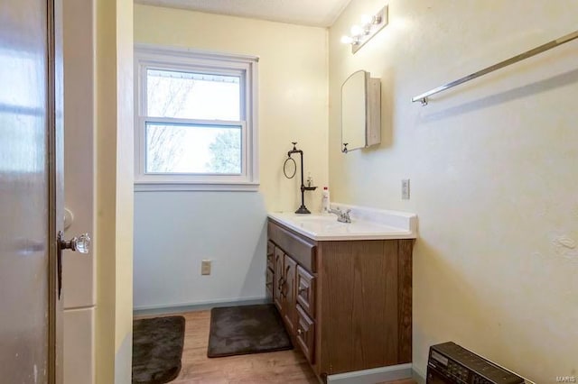 bathroom with wood-type flooring and oversized vanity