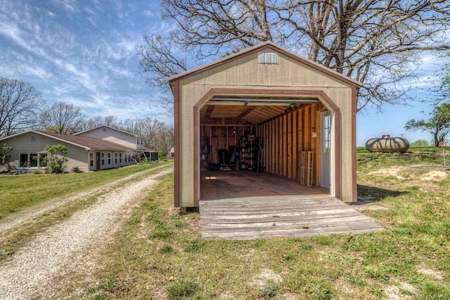 view of shed / structure with a yard and a garage