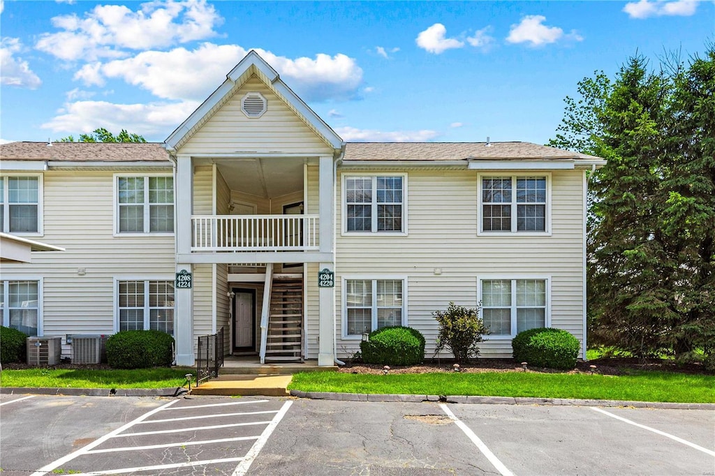 townhome / multi-family property featuring a balcony and central air condition unit