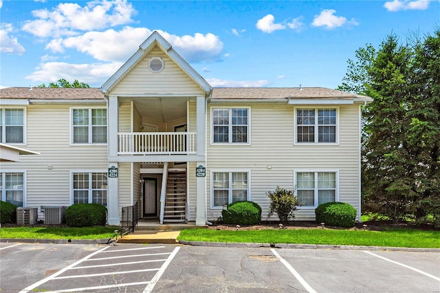 townhome / multi-family property featuring a balcony and central air condition unit