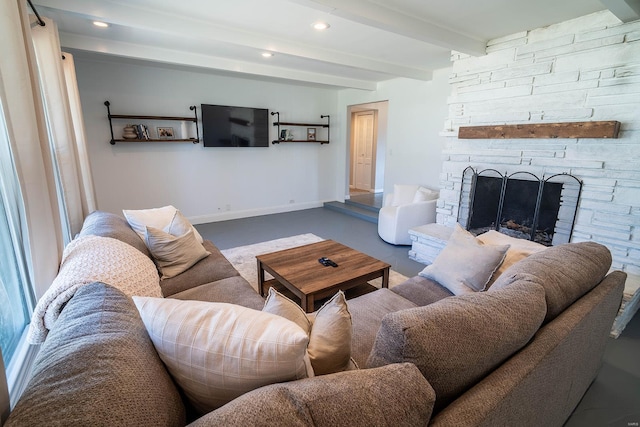 living room featuring beamed ceiling and a fireplace