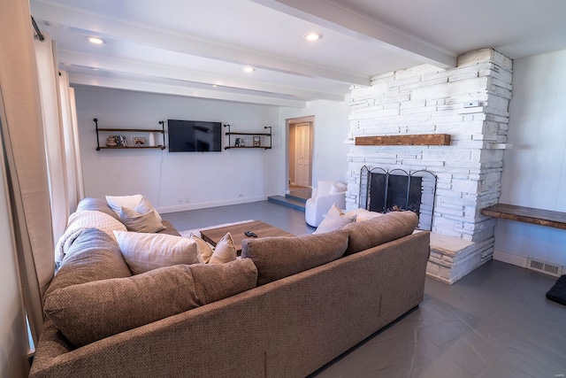 living room with a fireplace and beamed ceiling