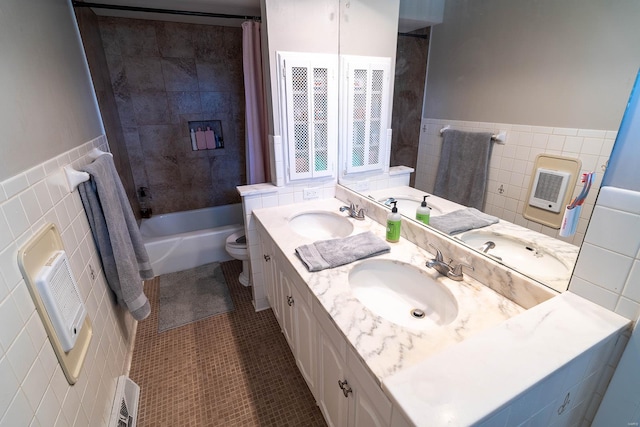 full bathroom with tile patterned flooring, shower / bath combination with curtain, toilet, vanity, and tile walls