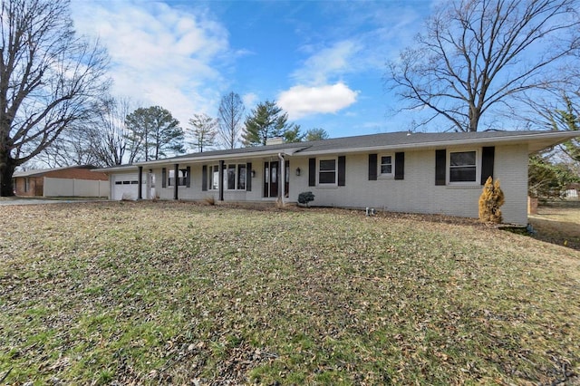 single story home featuring a garage and a front lawn