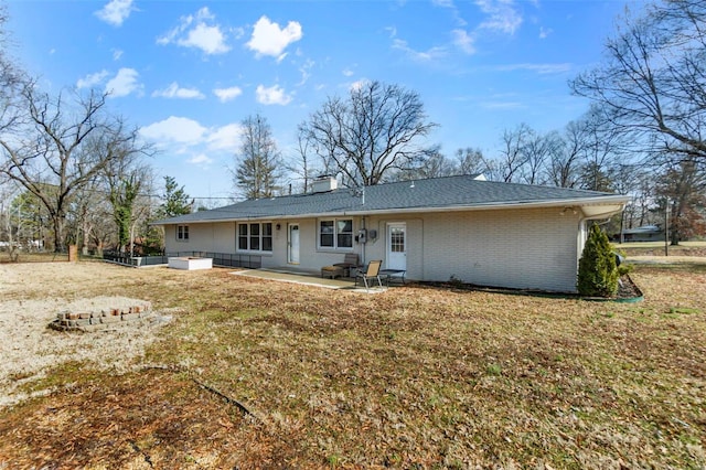 back of property featuring a lawn and a patio